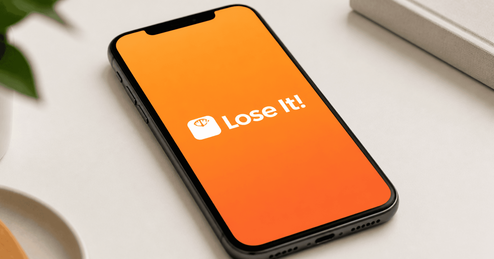 A close-up of an iPhone screen showing the Lose It! logo